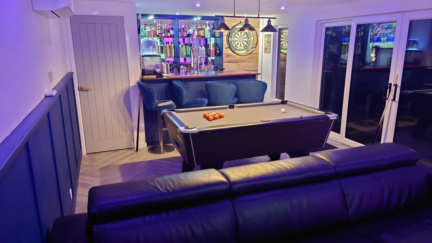 Garden room interior with pool table, home bar and lounge seating