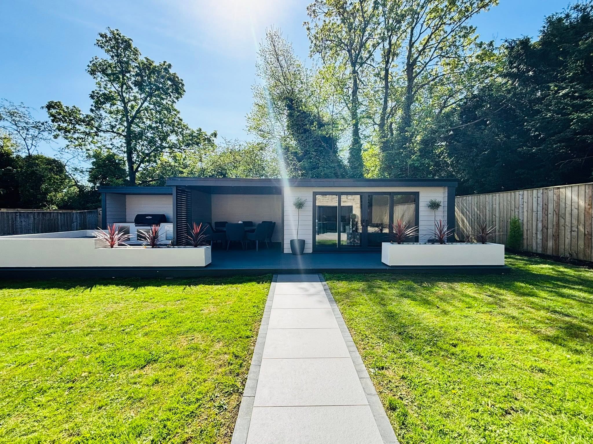 Modern garden room with outdoor kitchen, dining area and bi-fold doors